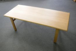A contemporary light oak coffee table