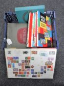 A basket containing nine assorted mid 20th century stamp albums with stamps including seven Royal