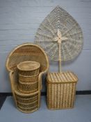 A wicker peacock chair with stool together with an linen box and fan