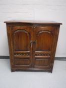 A reproduction oak audio cabinet