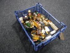 A basket containing approximately thirty assorted whisky miniatures