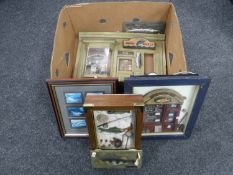 A box containing two framed fishing montages,