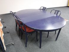 A circular blue extending kitchen table with two leaves together with four bentwood style chairs