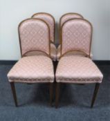 A set of four beech dining chairs in pink floral covering