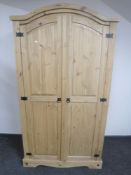 A pine arch topped double door wardrobe