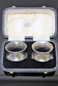 A pair of silver napkin rings, boxed.