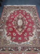 Two fringed Persian design rugs on red ground