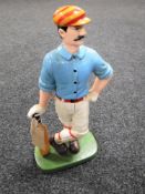 A cast iron cricketer door stop