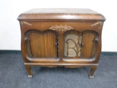 An early 20th century oak cased gramophone in cabinet by Gilbert