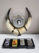 A box containing four boxed Zippo lighters together with a cow horn barometer