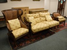An oriental style three piece lounge suite, comprising of high backed armchair,