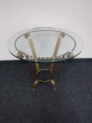 A circular gilded wrought iron glass topped occasional table