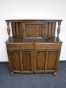 An oak linen fold buffet back sideboard