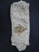 A pair of gold coloured floral curtains with tie backs