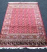 A Bokhara carpet 230 cm x 160 cm on red ground