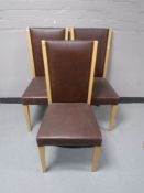 Three brown faux leather dining chairs
