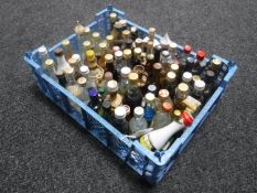A basket containing approximately seventy-five alcohol miniatures
