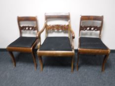 A late 19th century scroll armchair and a pair of matching dining chairs