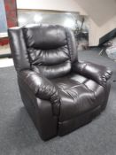A brown leather manual reclining armchair