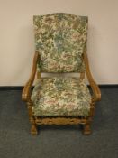 A continental carved oak armchair with tapestry seat