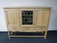 A continental triple door oak sideboard