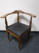 An early 20th century oak corner chair