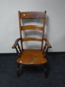 A late 19th century pine kitchen high back armchair CONDITION REPORT: An old split