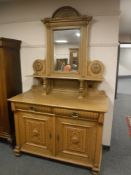 An early 20th century light oak mirror backed sideboard,