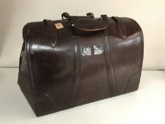 A vintage leather Gladstone bag