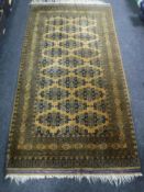 A Bokhara style rug on gold ground,