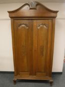 A continental oak double door cabinet,