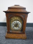 An oak cased bracket clock with brass dial
