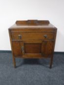 An early 20th century oak cabinet fitted a drawer