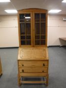 An early 20th century oak bureau bookcase