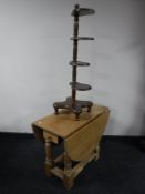 A blonde oak gate leg coffee table and a four tier what not stand