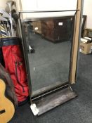 A chrome framed mirror with shelf