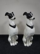 A large pair of metal dog figures on stands