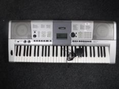 A Yamaha PSRE403 electric keyboard with lead
