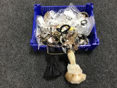 A basket of costume jewellery and jewellery stands