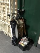 Two golf bags containing irons and drivers,