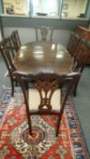 A late Victorian carved mahogany extending oval dining table, with leaf and winder,