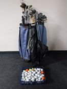 Two golf bags containing irons and drivers and a basket of golf balls