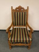 A continental carved oak armchair with striped fabric