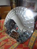 A contemporary circular mirror, diameter 100 cm.