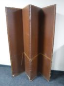 An early 20th century leather four way folding room divider