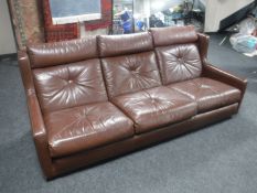 A mid 20th century brown leather settee