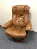 A tan leather Stressless swivel adjustable armchair