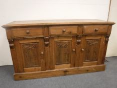 A rustic pine triple door sideboard