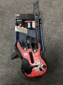 A crate of Guitar Hero guitar, boxed Braun shaver, Xbox control unit,