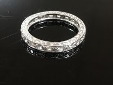 A white metal diamond full eternity ring, size K/L.